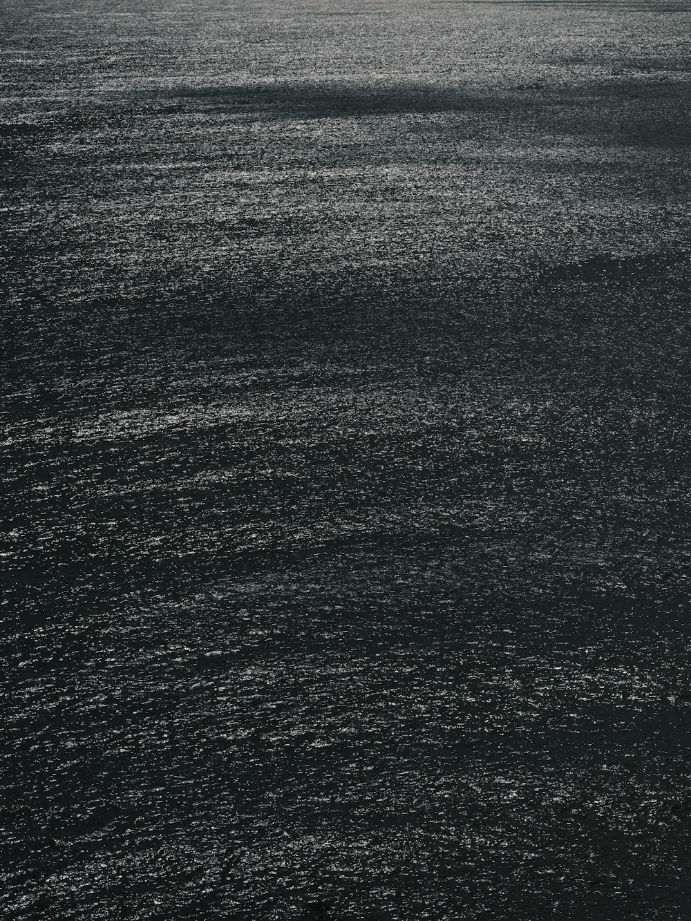 a large body of water with a boat in the distance