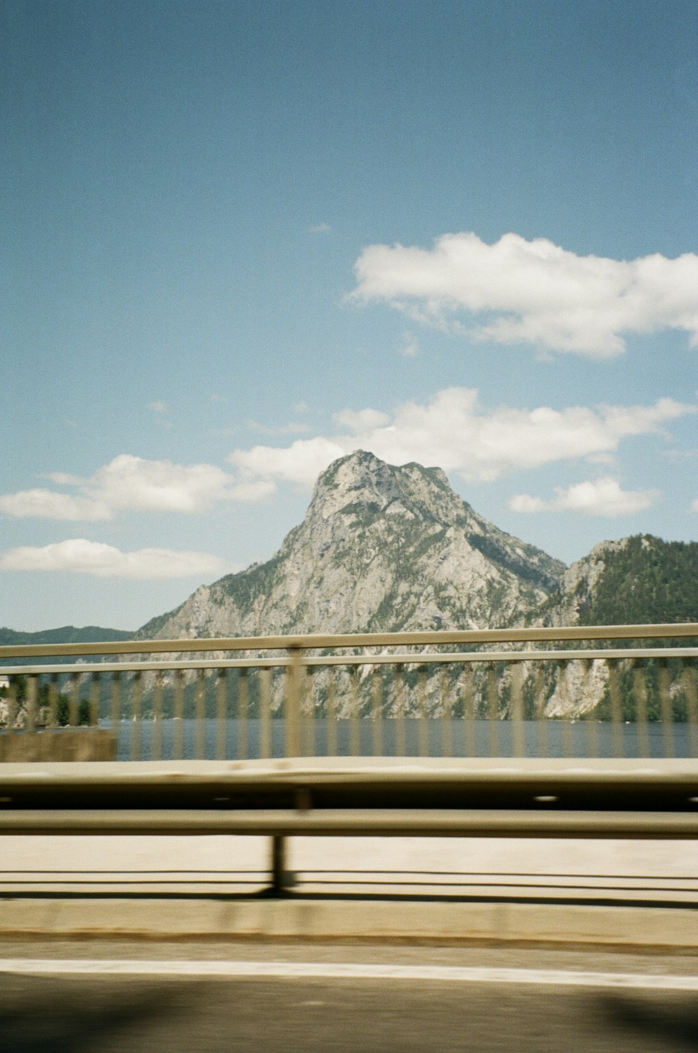 a view of a mountain from a moving vehicle