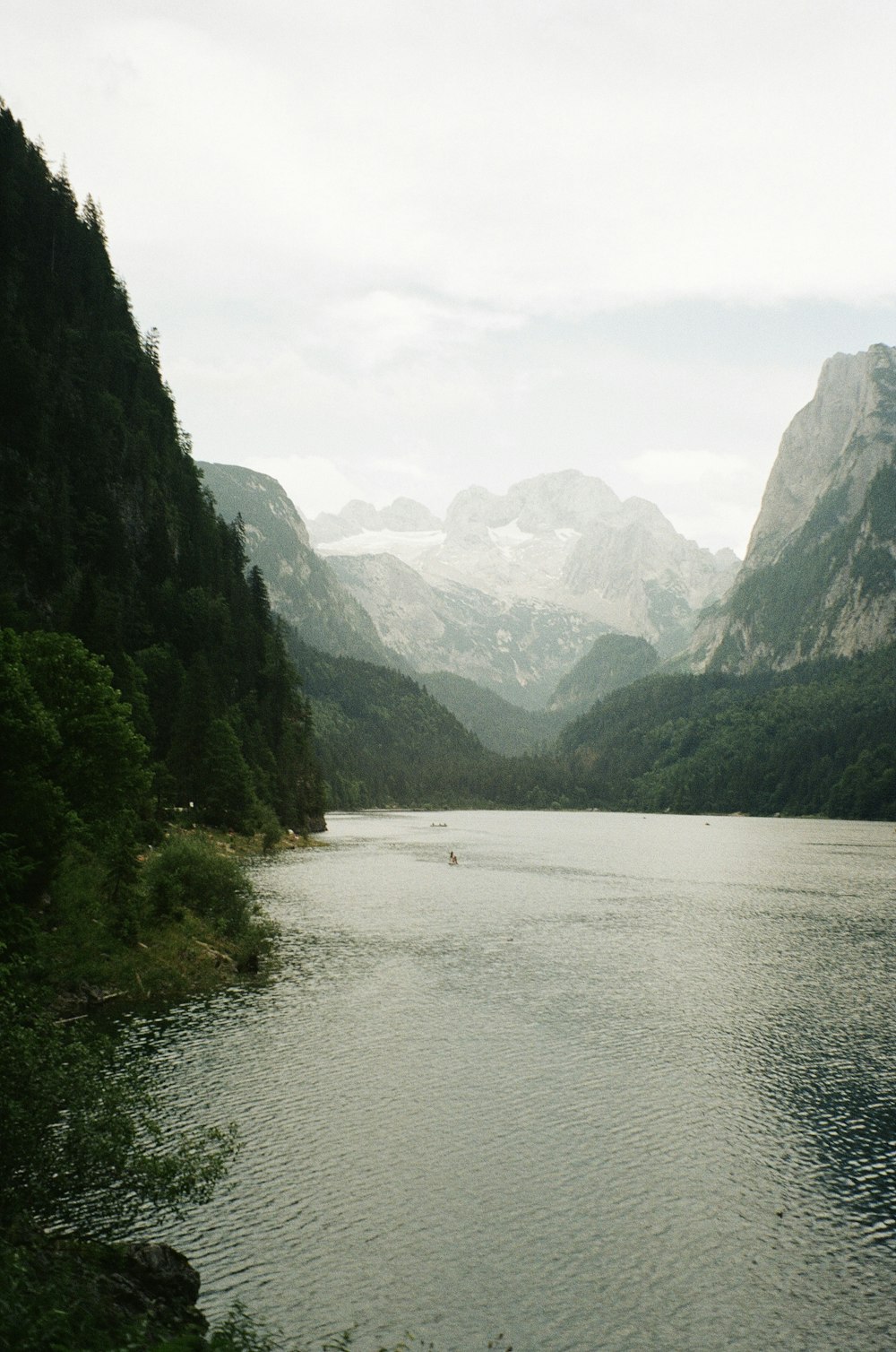 a body of water surrounded by mountains and trees