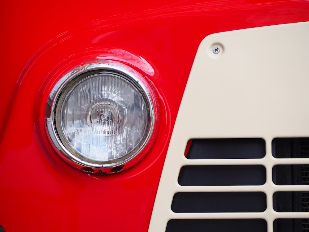 a close up of a red and white car headlight