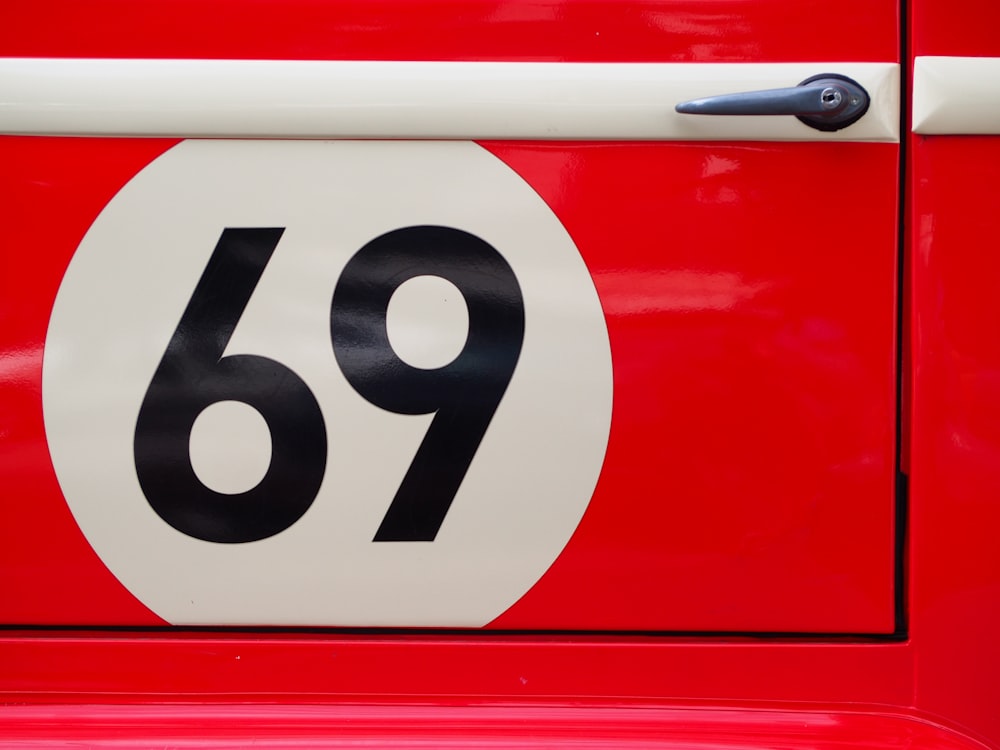 a close up of a number plate on a red car