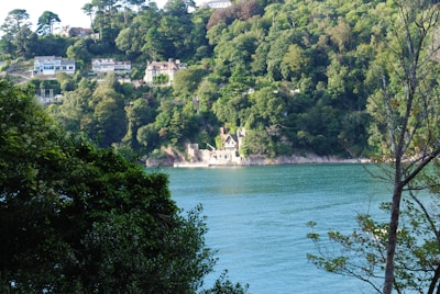 A serene view of Haridwar's lush green land plots with the Ganges river in the background at sunrise.
