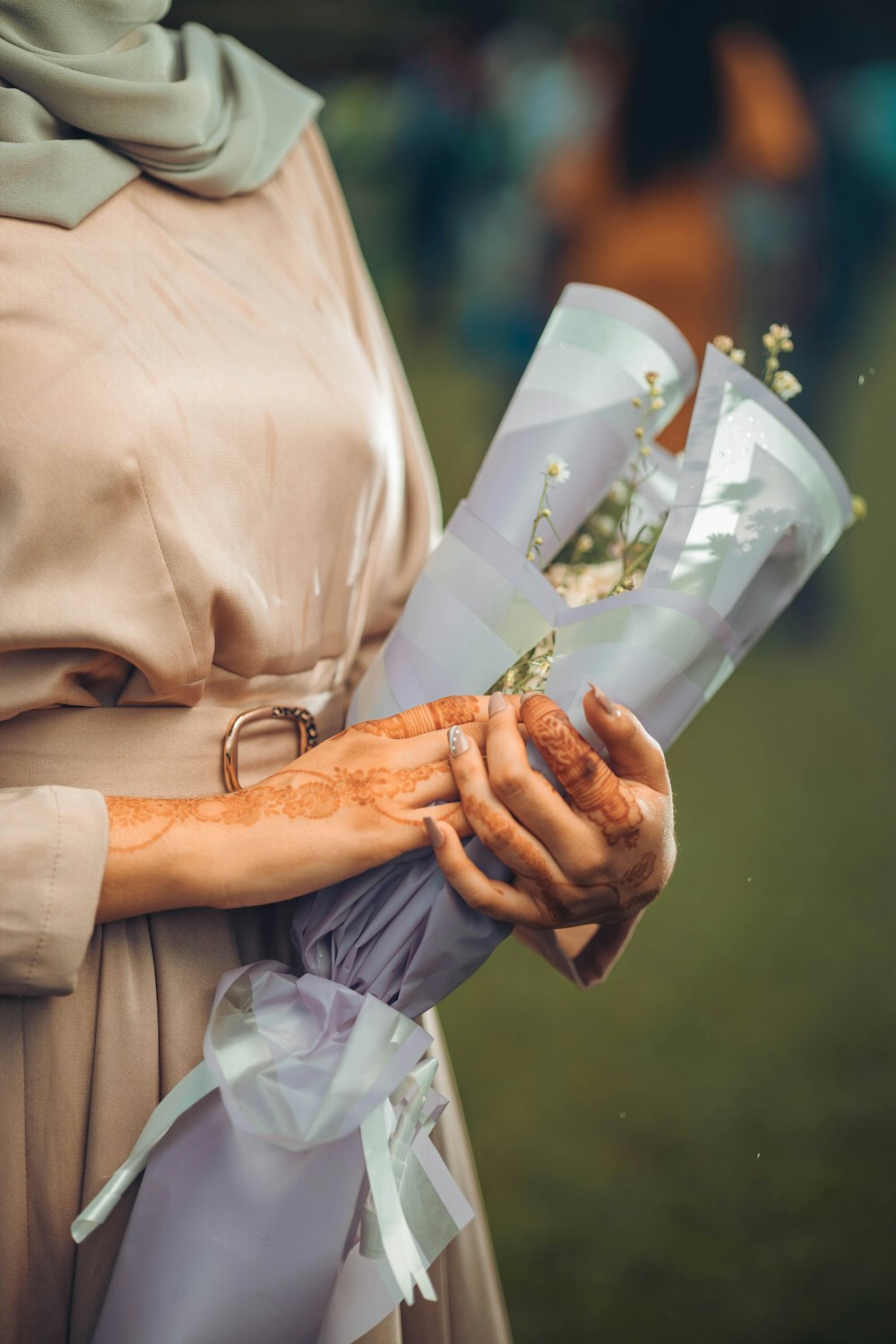 a woman in a dress holding a bouquet of flowers