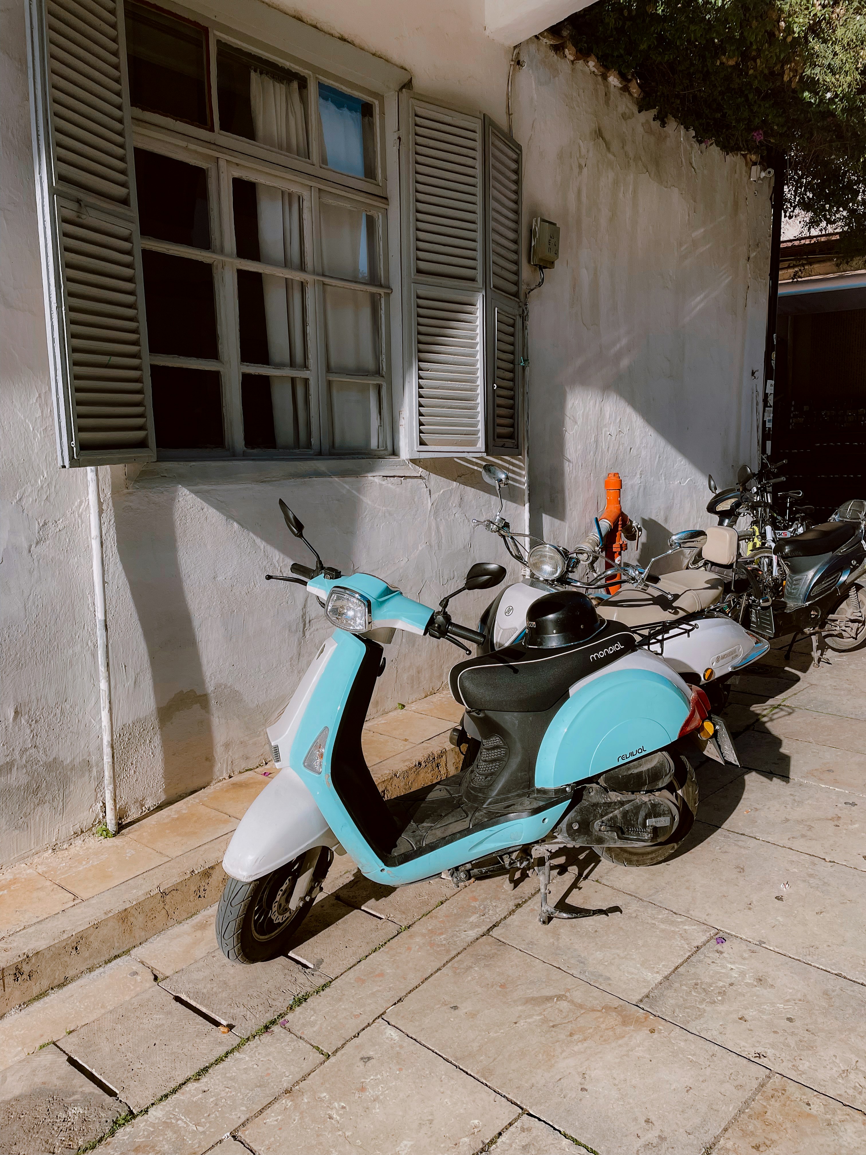 a scooter parked on the side of a building