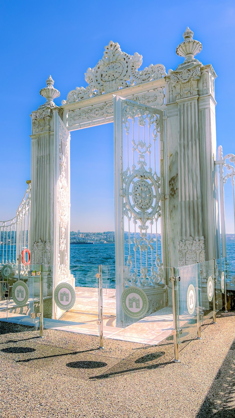 a large white gate sitting on top of a sandy beach