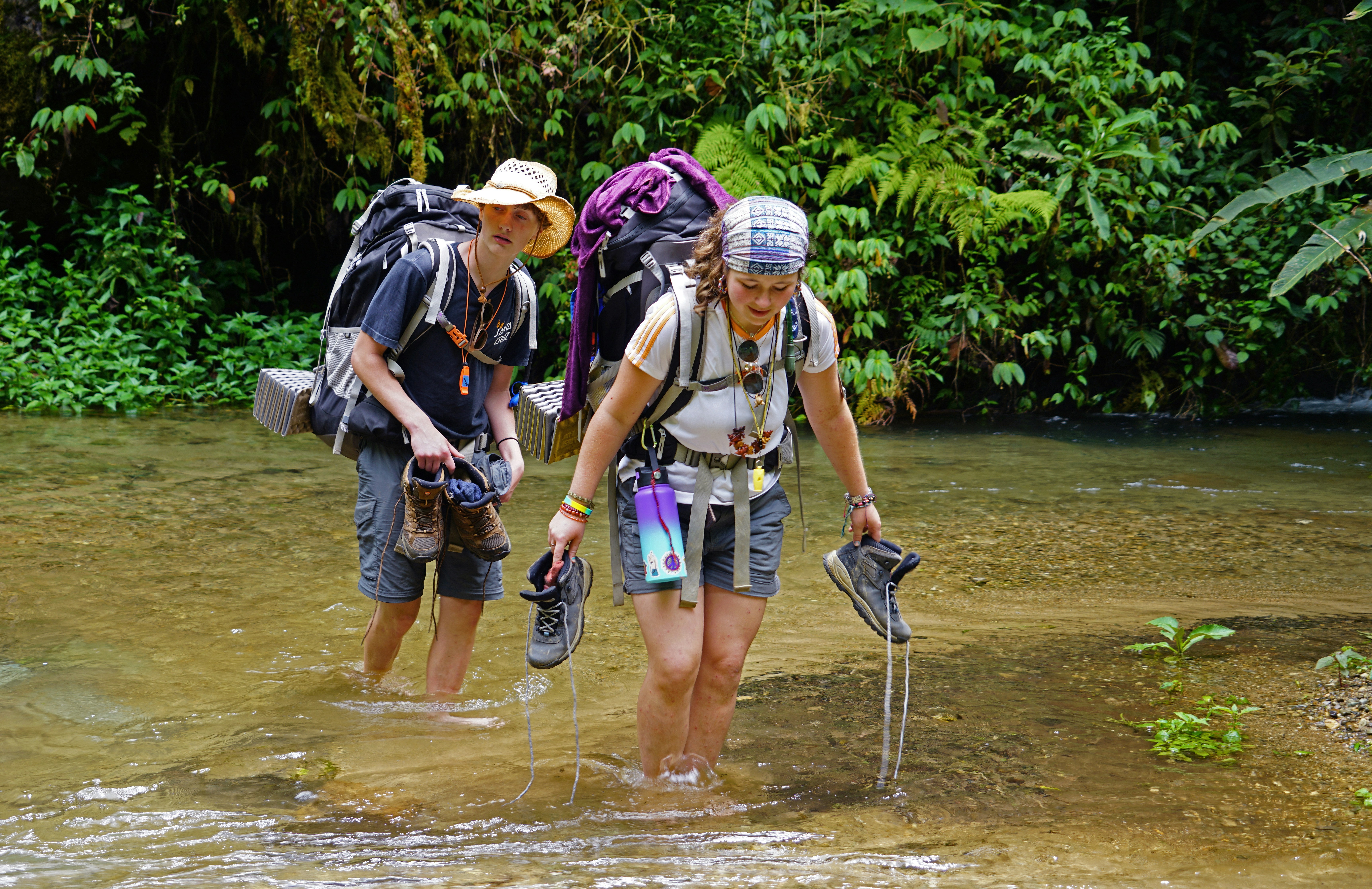 a couple of people that are walking in some water
