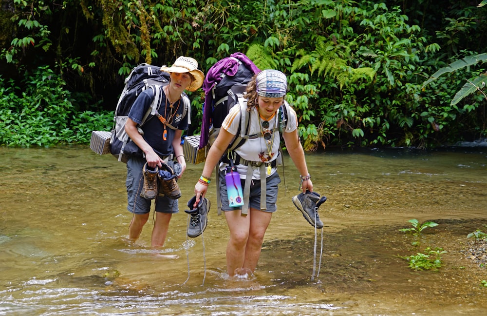 a couple of people that are walking in some water