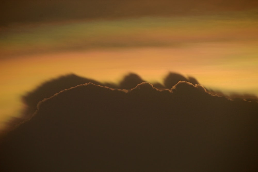 a group of clouds in the sky at sunset