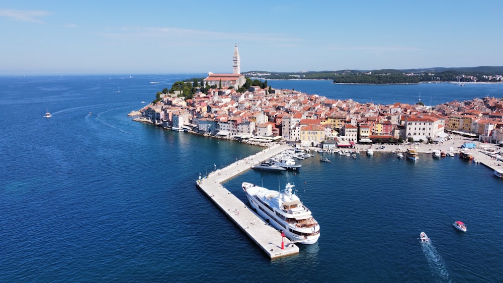 an aerial view of a harbor with a cruise ship in the water