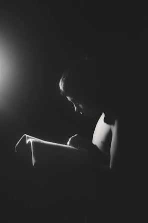 A young adult reading aloud passionately during an online community reading event.
