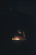 A reader engrossed in a thick book under warm lighting
