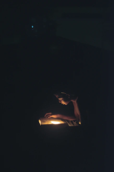 An intimate reading session with an author engaging the audience in a softly lit space.