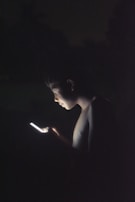 Close-up of a user browsing an interactive digital product on a laptop, glow from the screen illuminating their face.