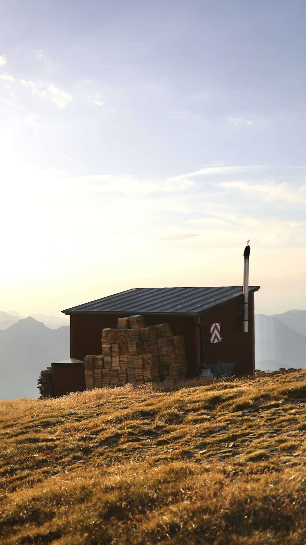 a small building on top of a grassy hill