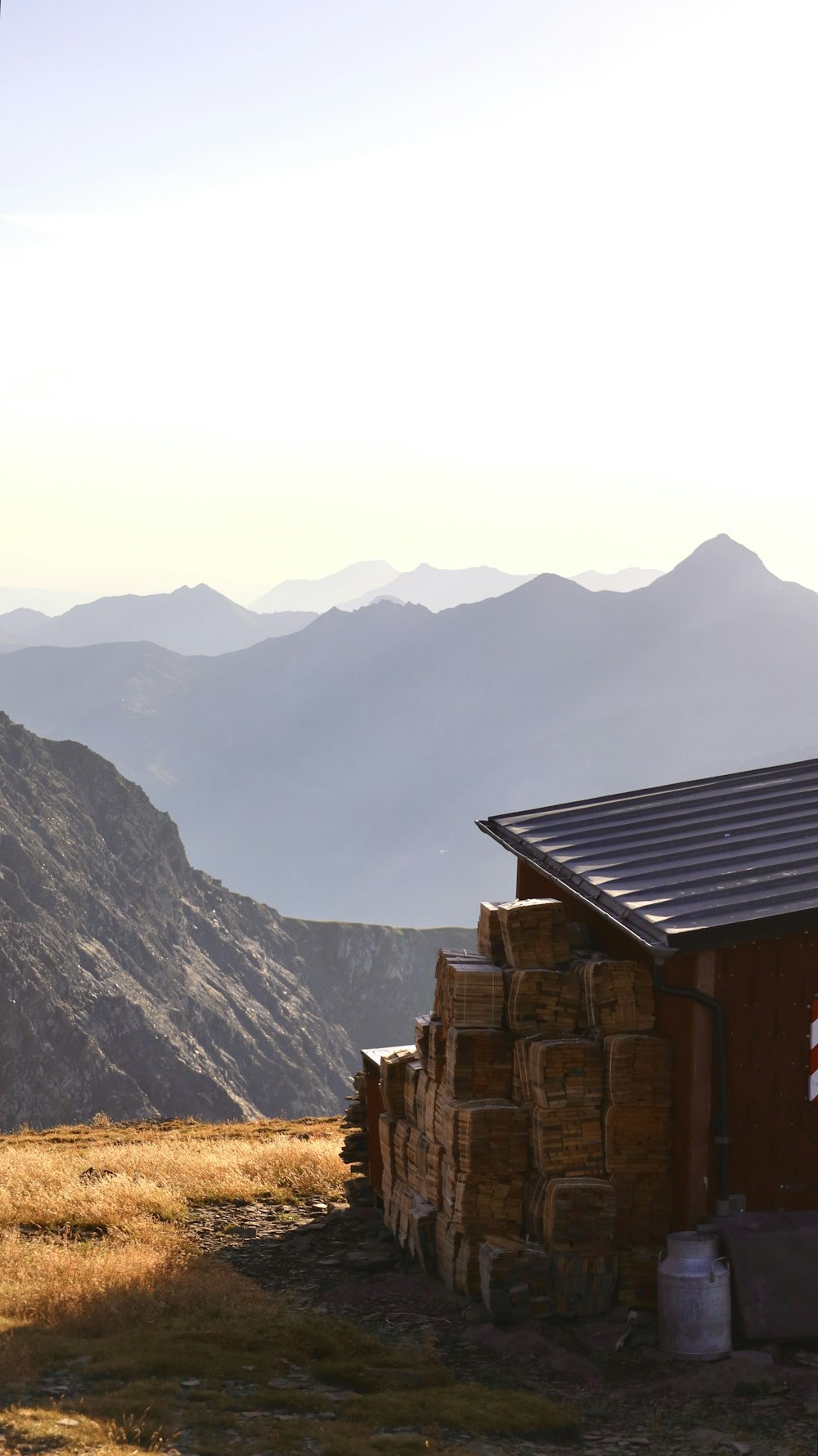 a building on top of a hill with mountains in the background