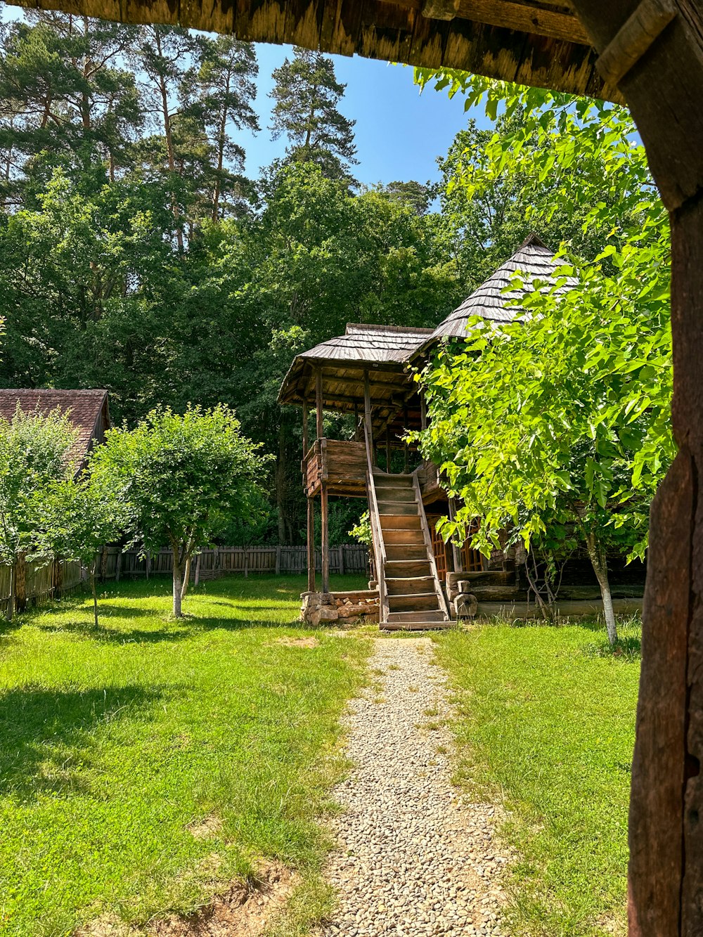 a small wooden cabin in the middle of a forest