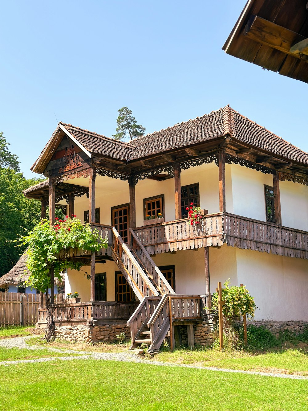 a white and brown house with a wooden balcony
