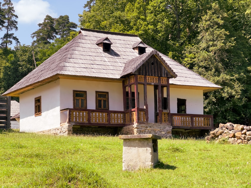 a small white house with a brown roof