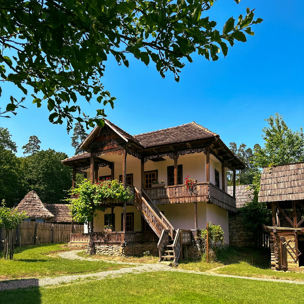 an old house with a wooden staircase leading to a second story