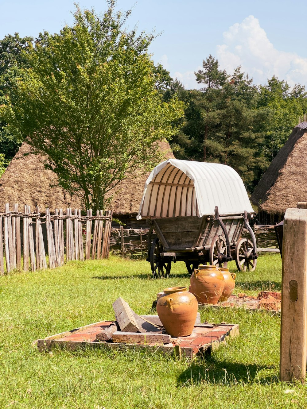 a wagon sitting on top of a lush green field