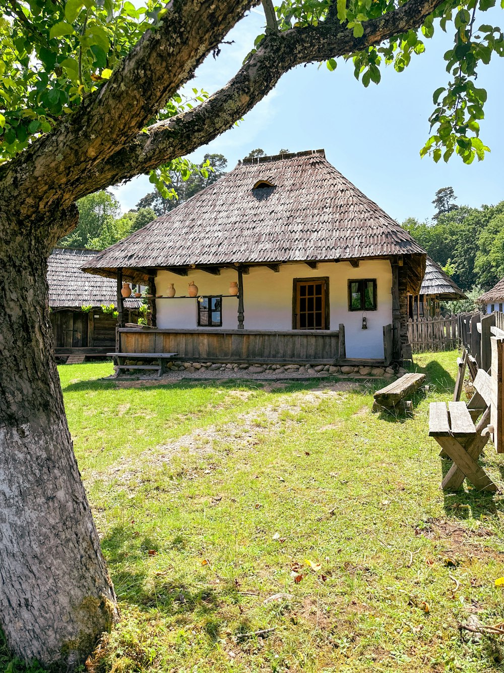 a small white house with a thatched roof