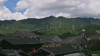 A group of happy tourists exploring a scenic mountain village in Guizhou.
