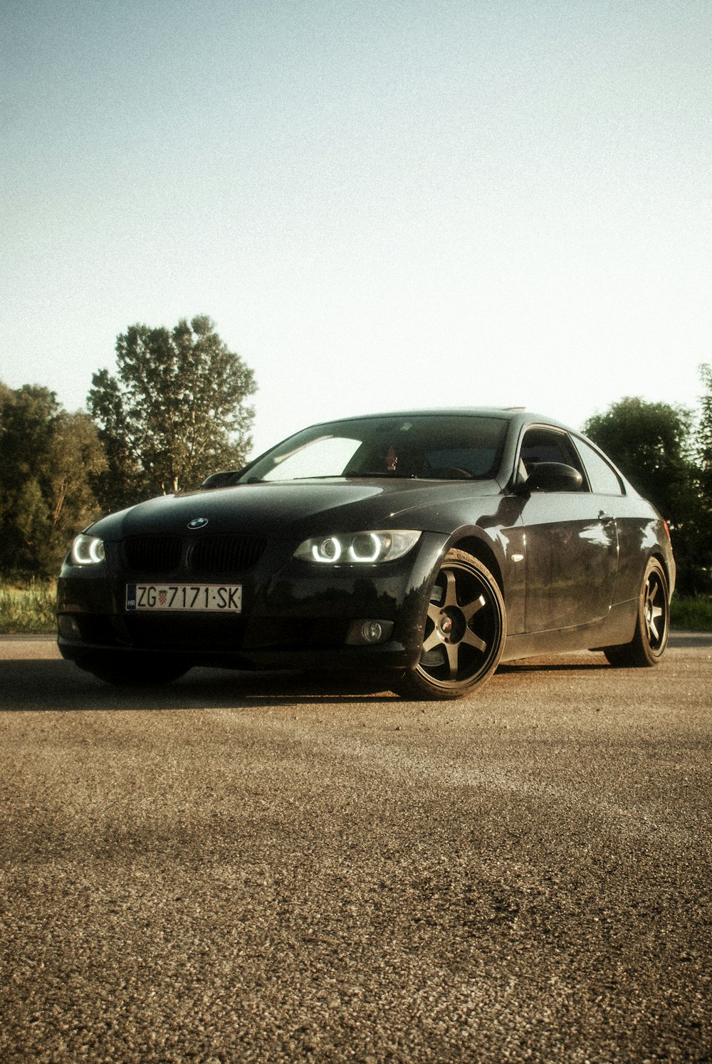 a black car parked on the side of the road