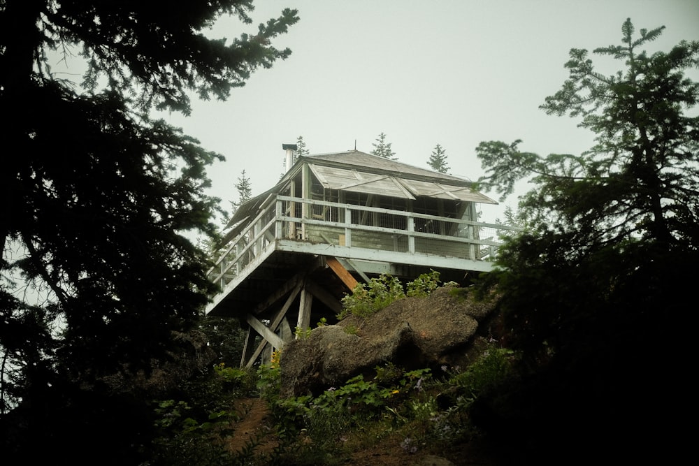 a house on top of a hill surrounded by trees