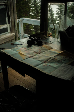 A collection of cryptic symbols and maps spread across a dimly lit table.
