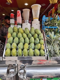 An artisan preparing fresh tropical juices with care.