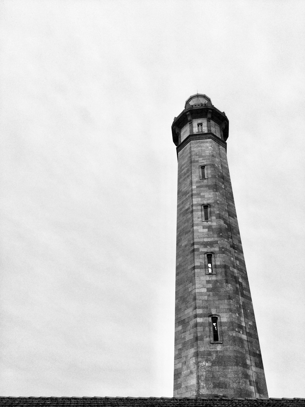 a black and white photo of a lighthouse