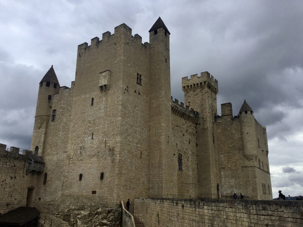 a very tall castle sitting on top of a stone wall