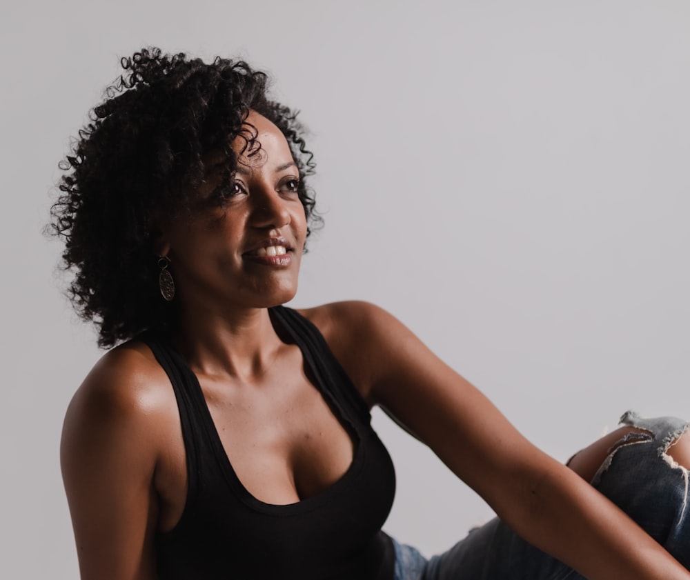 a woman sitting on a chair with her legs crossed