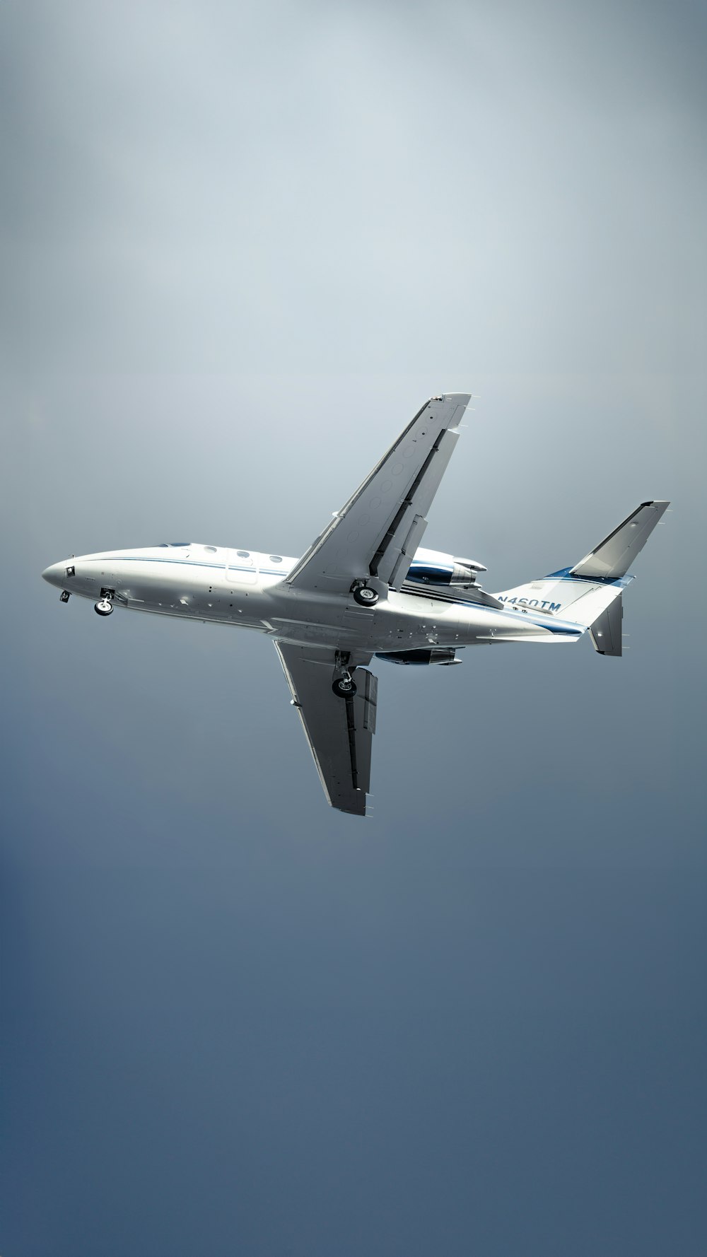 a large jetliner flying through a cloudy blue sky