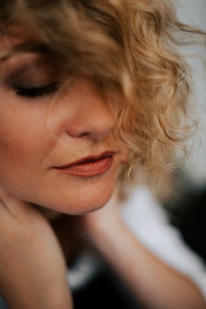 A close-up of a client enjoying a relaxing facial treatment with soft lighting.