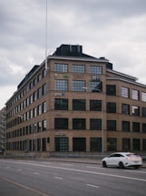 A sleek black and white photo of the company's main factory entrance on W University Road.