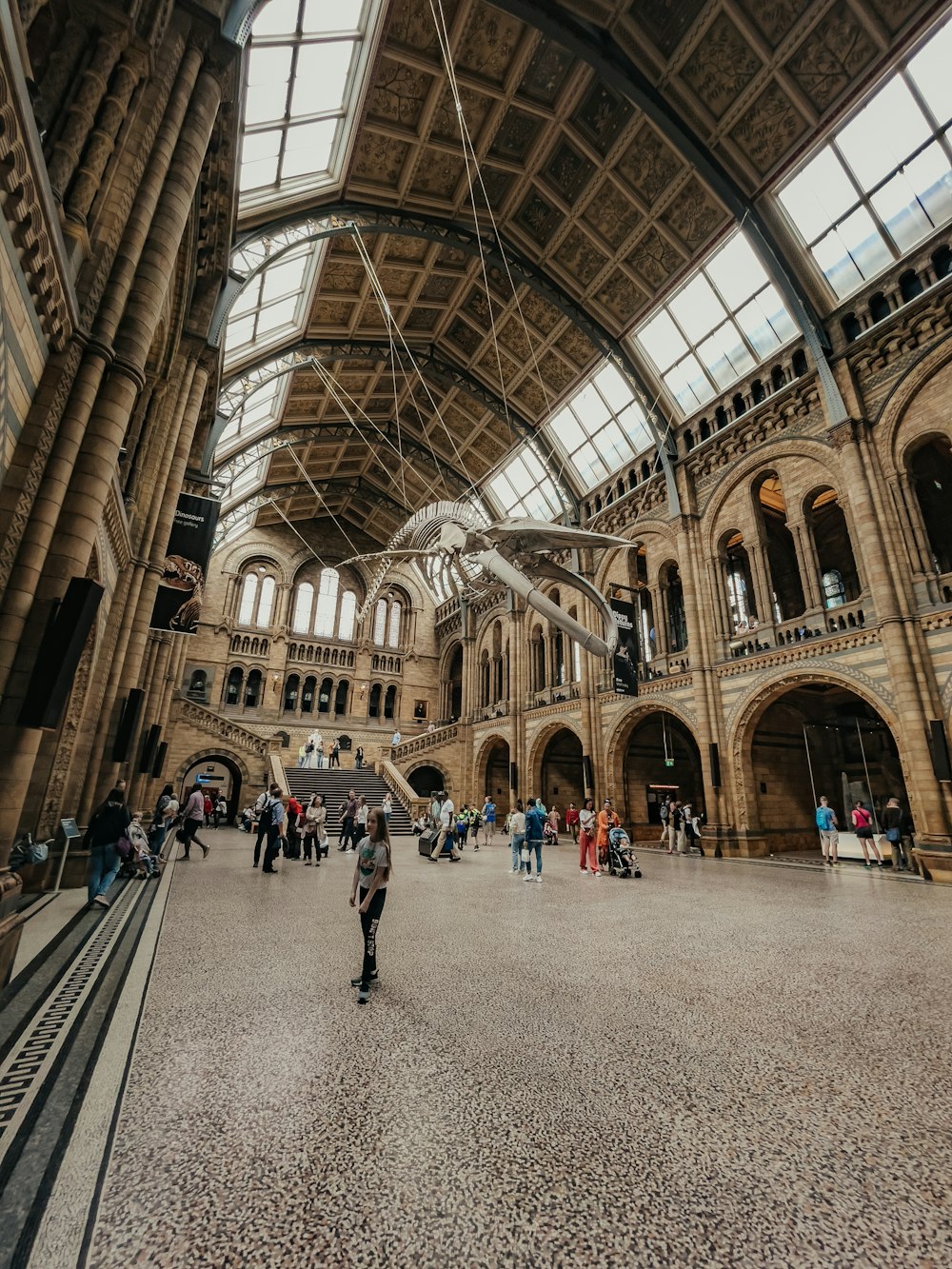 a man riding a skateboard inside of a large building