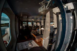 A specialist fitting a high-quality screen on a spacious recreational cabin window.