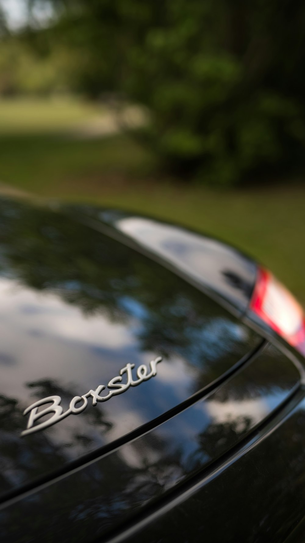 a close up of the trunk of a black sports car