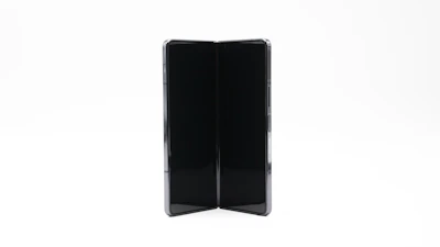 A hand folding a compact stand, showing its portability and ease of use.