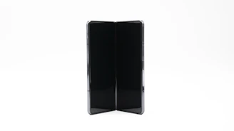 A hand folding a compact stand, showing its portability and ease of use.