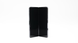 Close-up of hands folding up a stylish and lightweight folding table, highlighting its compact design and ease of use.