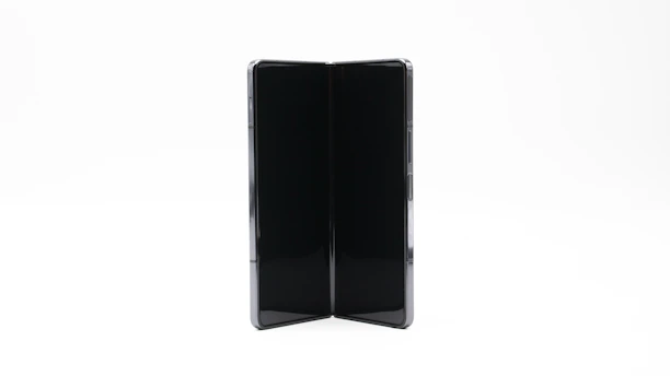 Close-up of hands unfolding a stylish foldease table, highlighting its smooth hinges.