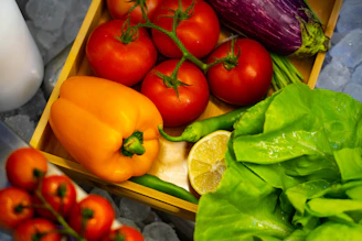 Fresh fruits and vegetables neatly arranged in a rustic wooden crate.
