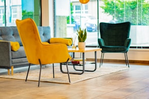 Modern living room with green and yellow accents, bright and inviting atmosphere