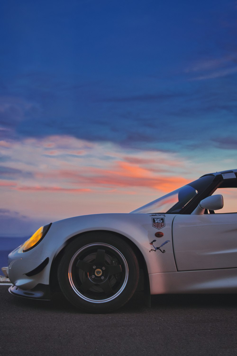 a silver sports car parked on the side of the road