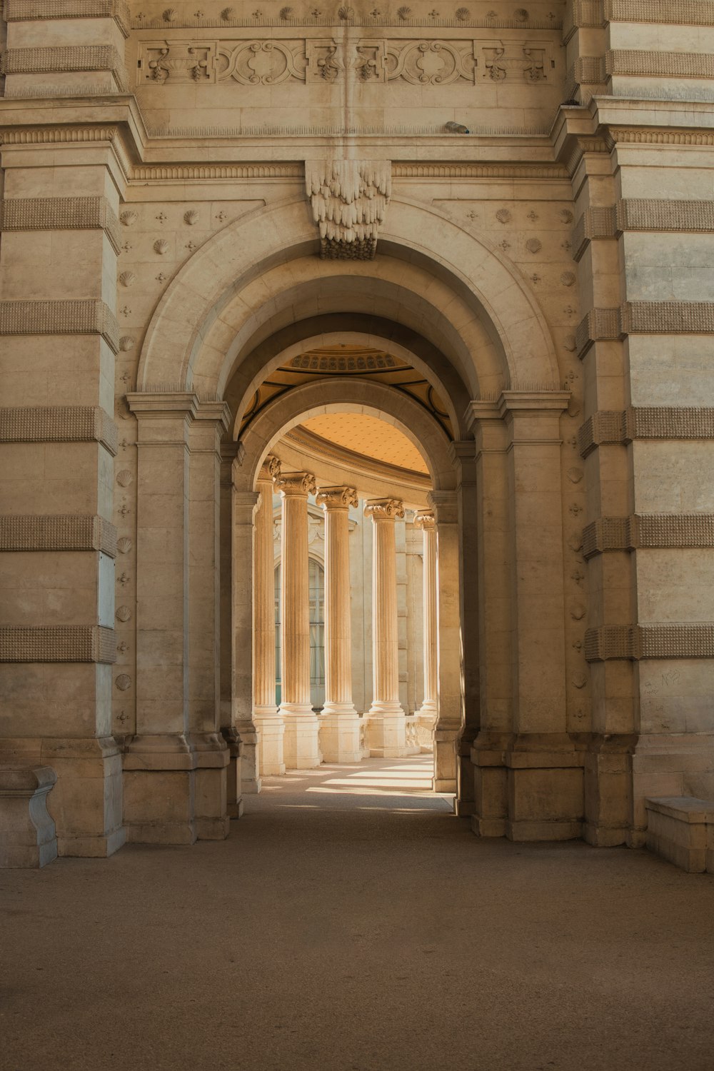 an archway leading into a building with columns