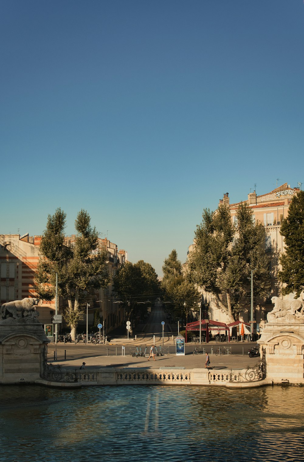 a body of water with a statue in the middle of it