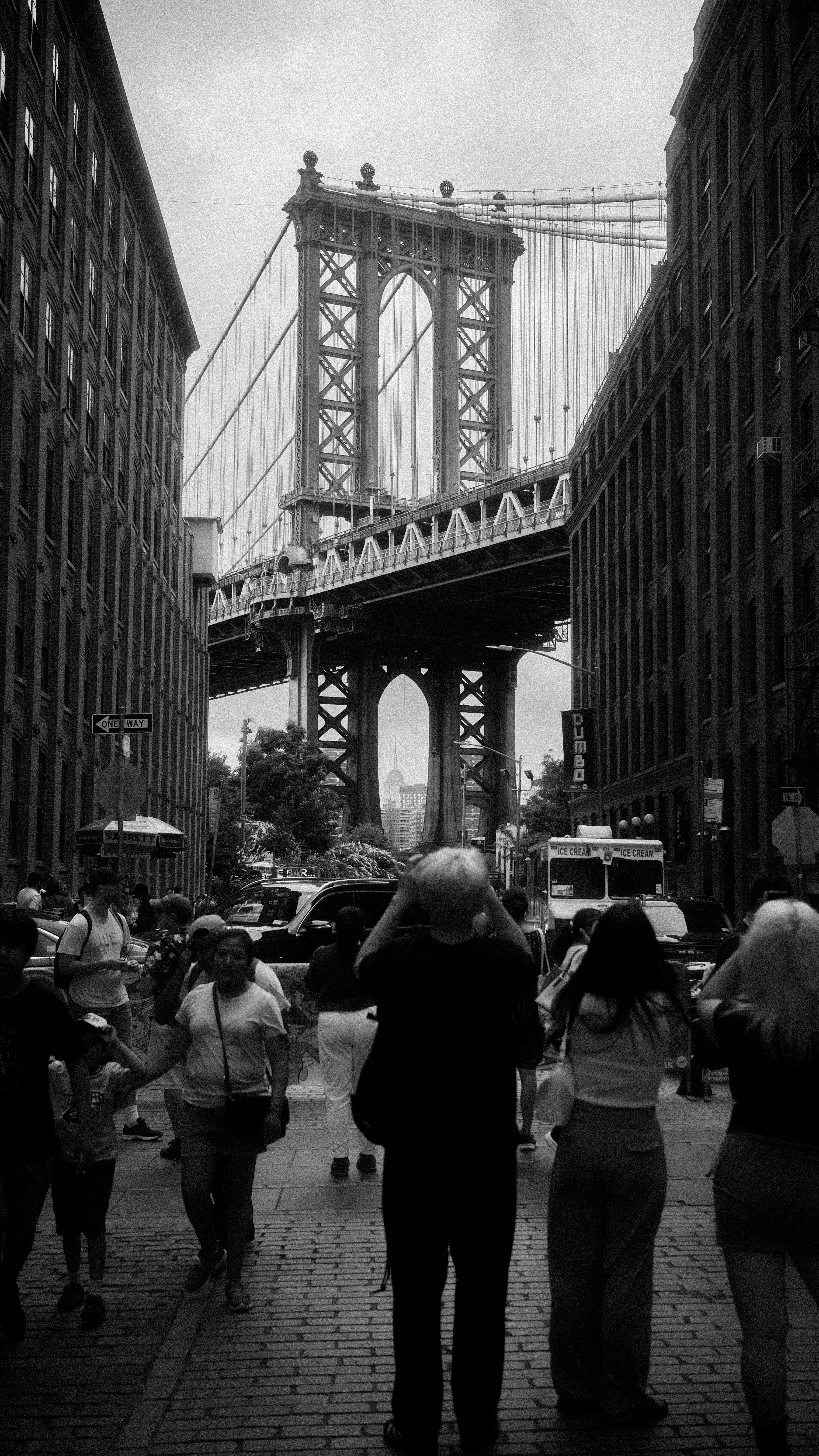 A group of people walking across a bridge photo – Free Dumbo Image on ...