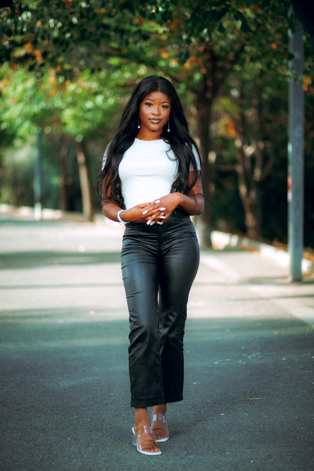 a woman in black pants and a white top